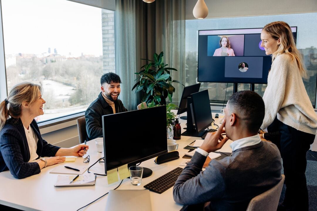 Web_Desktop-Happy business colleagues discussing with each other in conference room at office