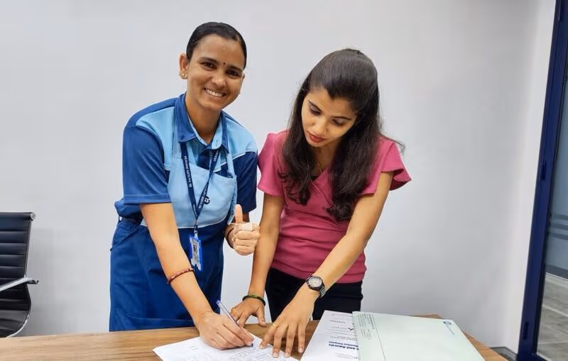 webimage-Two-women-signing-papers-crop